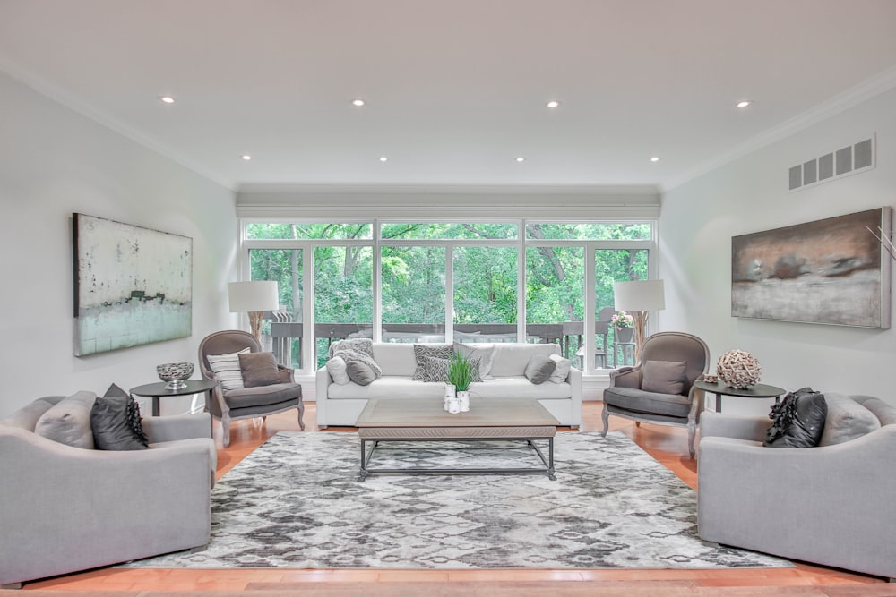 living room with white and brown area rug and brown leather armchair