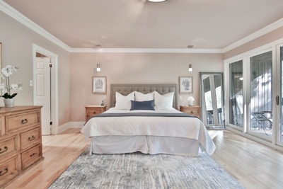 Spacious bedroom corner highlighting a well-kept king-size bed and matching nightstands.