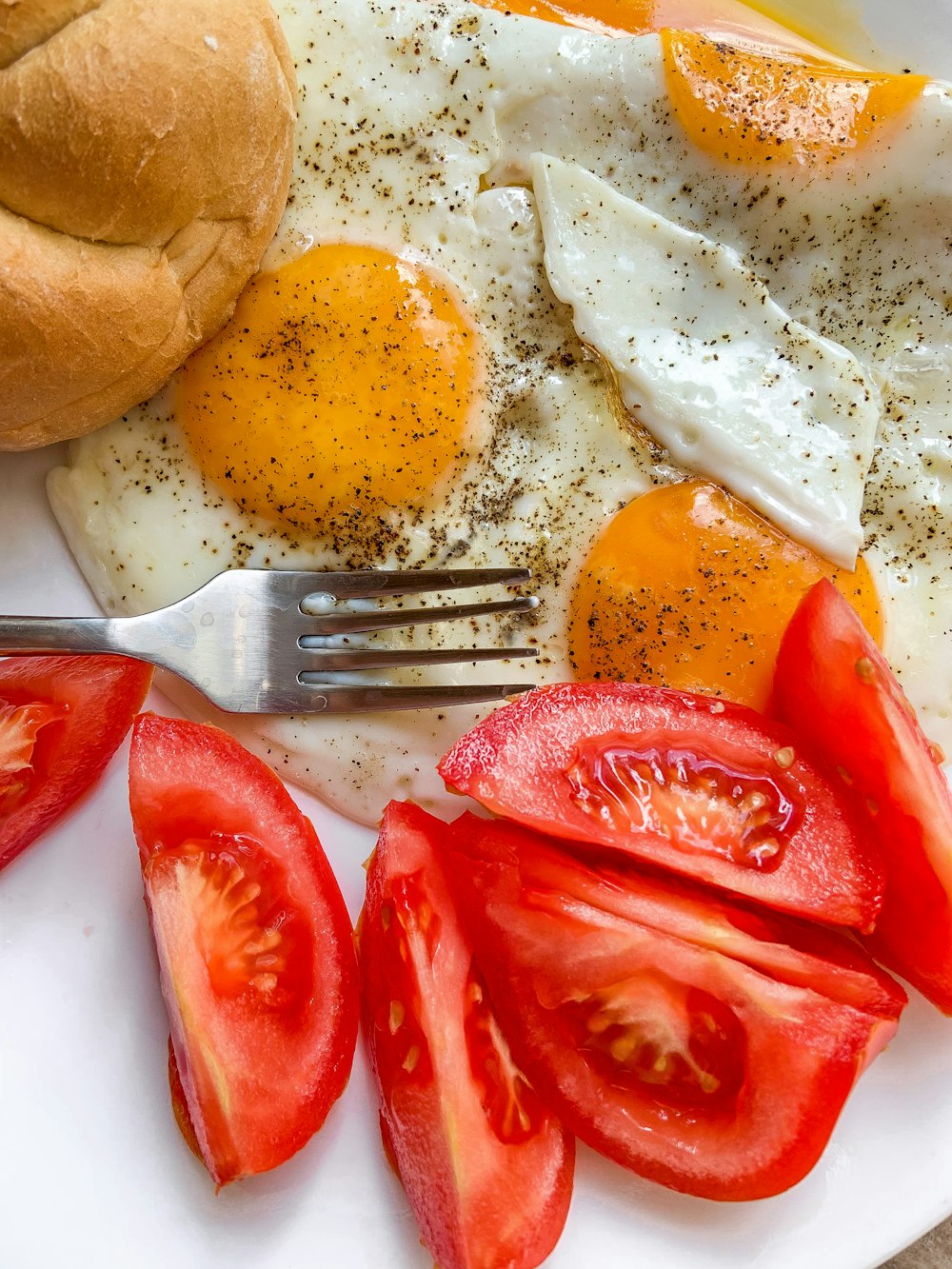 sliced tomato and bread on white ceramic plate