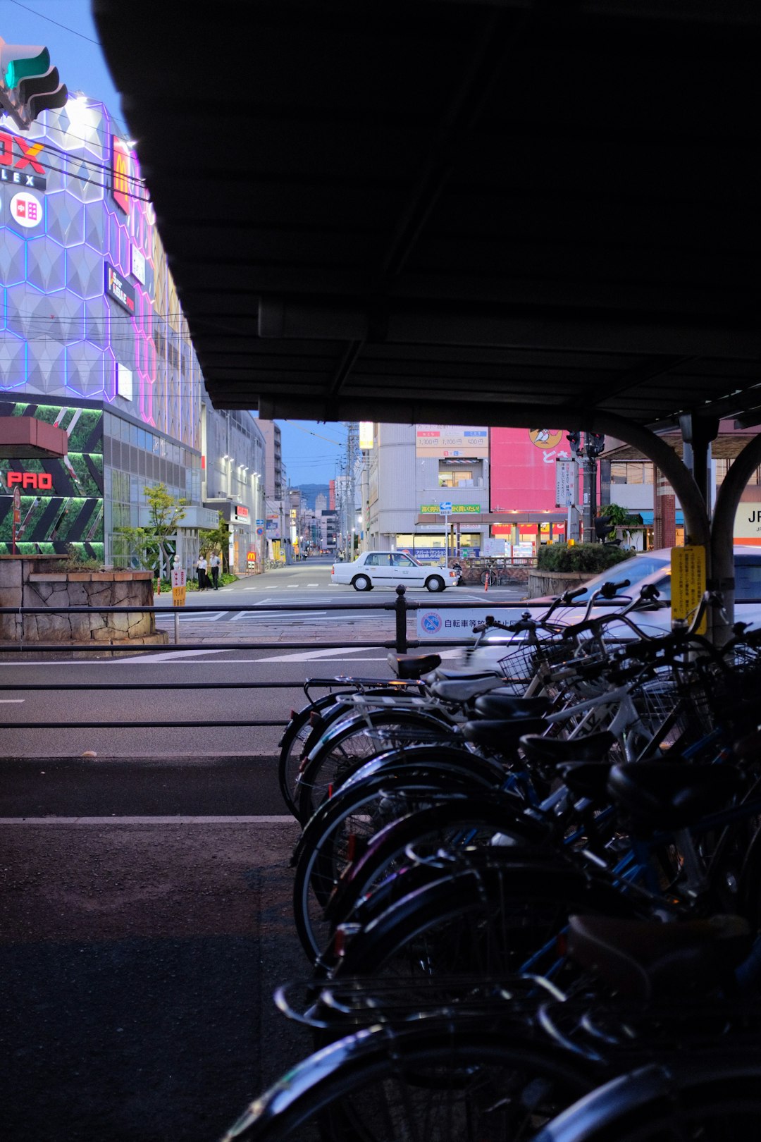 black motorcycle parked beside road during daytime