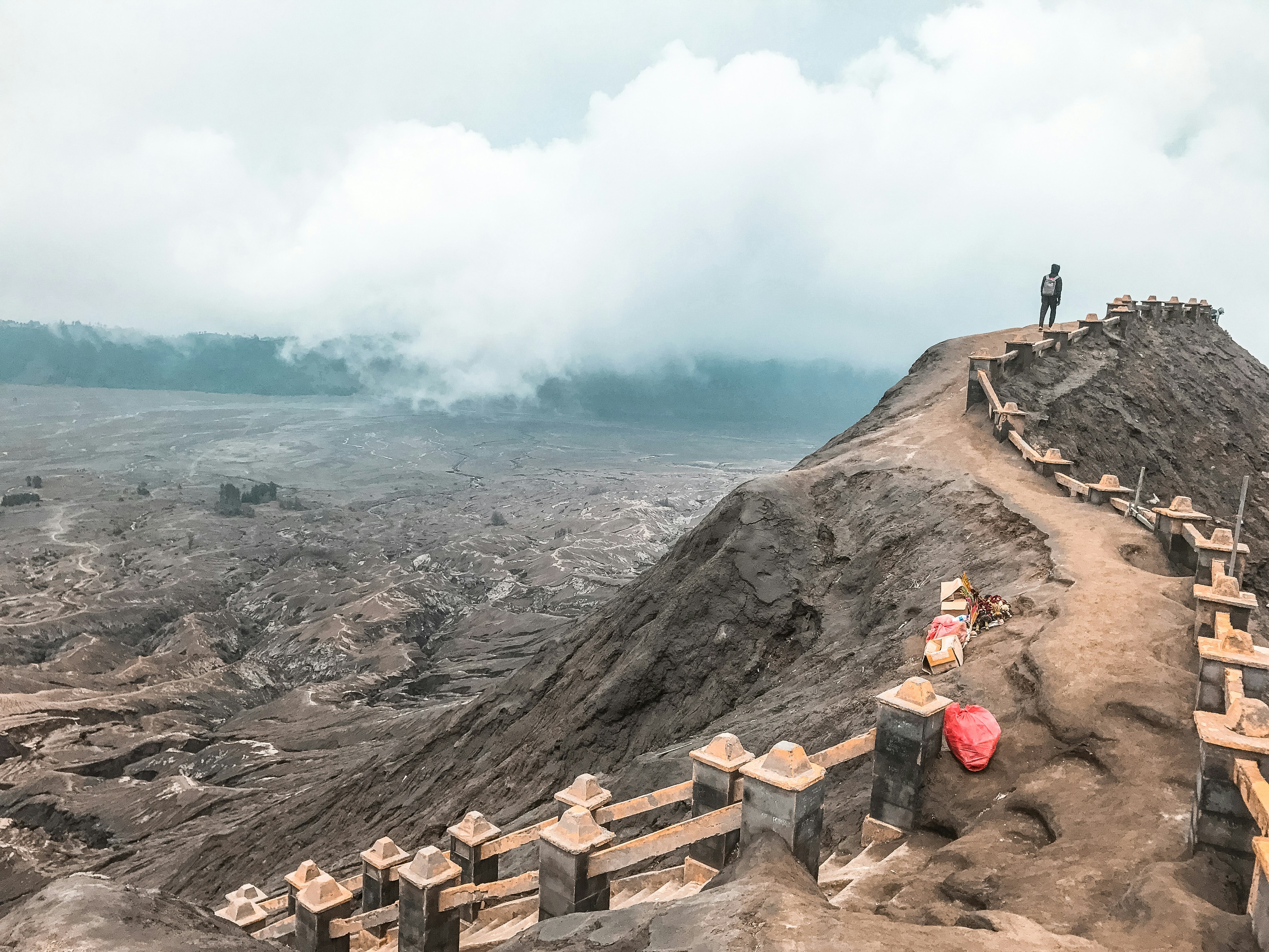 2 person standing on rocky hill during daytime