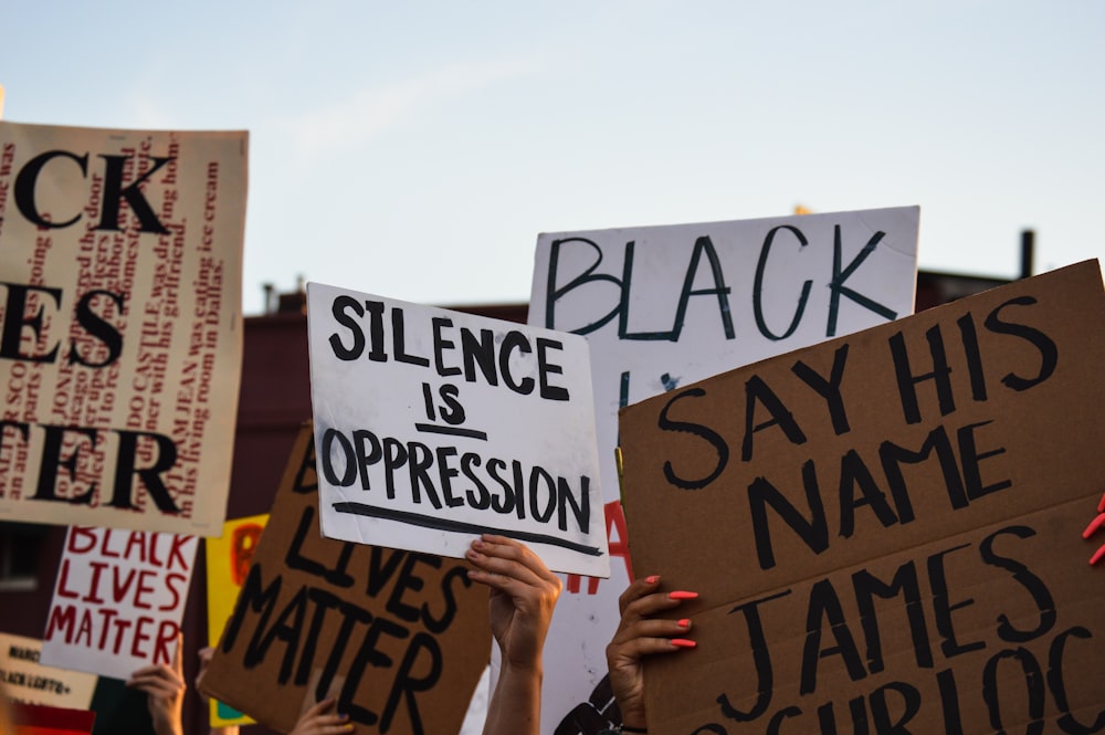 person holding white and black quote board