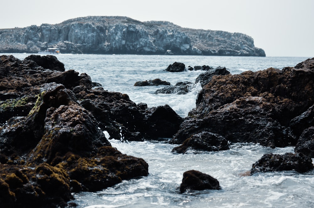 brown rock formation on sea during daytime