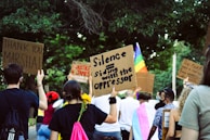 A peaceful demonstration organized by vnv with colorful signs and engaged participants.