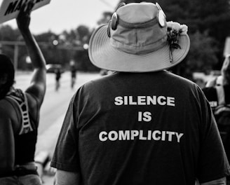 grayscale photo of man wearing hat and t-shirt