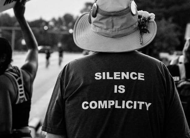 grayscale photo of man wearing hat and t-shirt