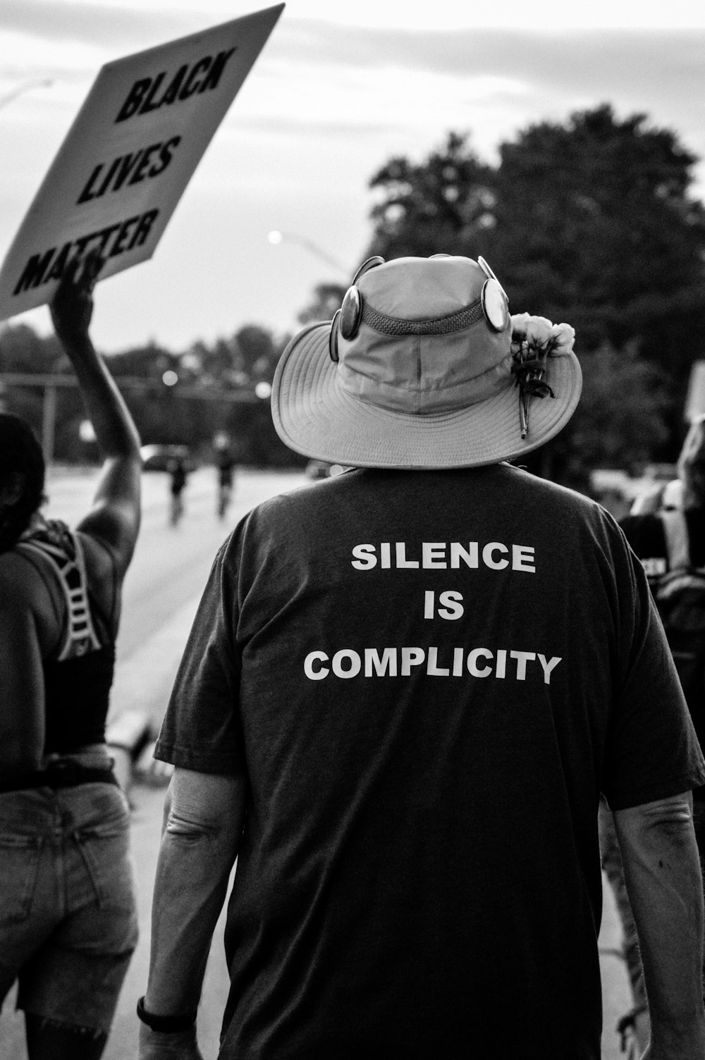 grayscale photo of man wearing hat and t-shirt