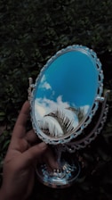 blue and silver round mirror