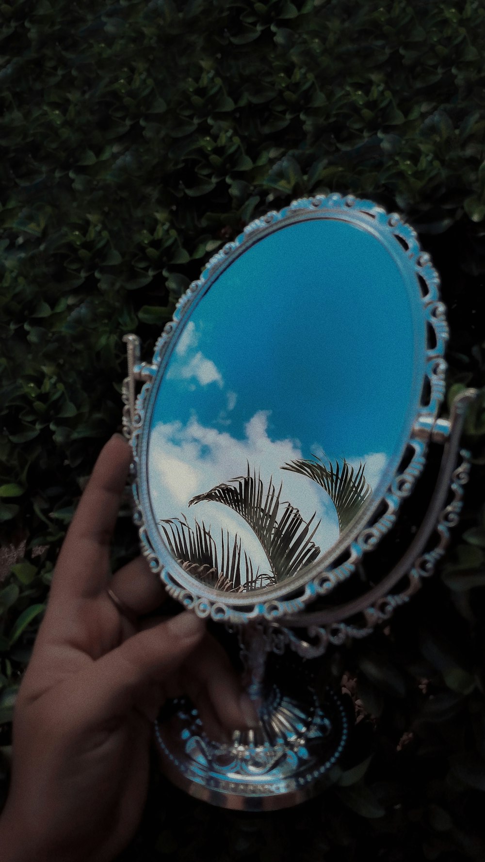 blue and silver round mirror