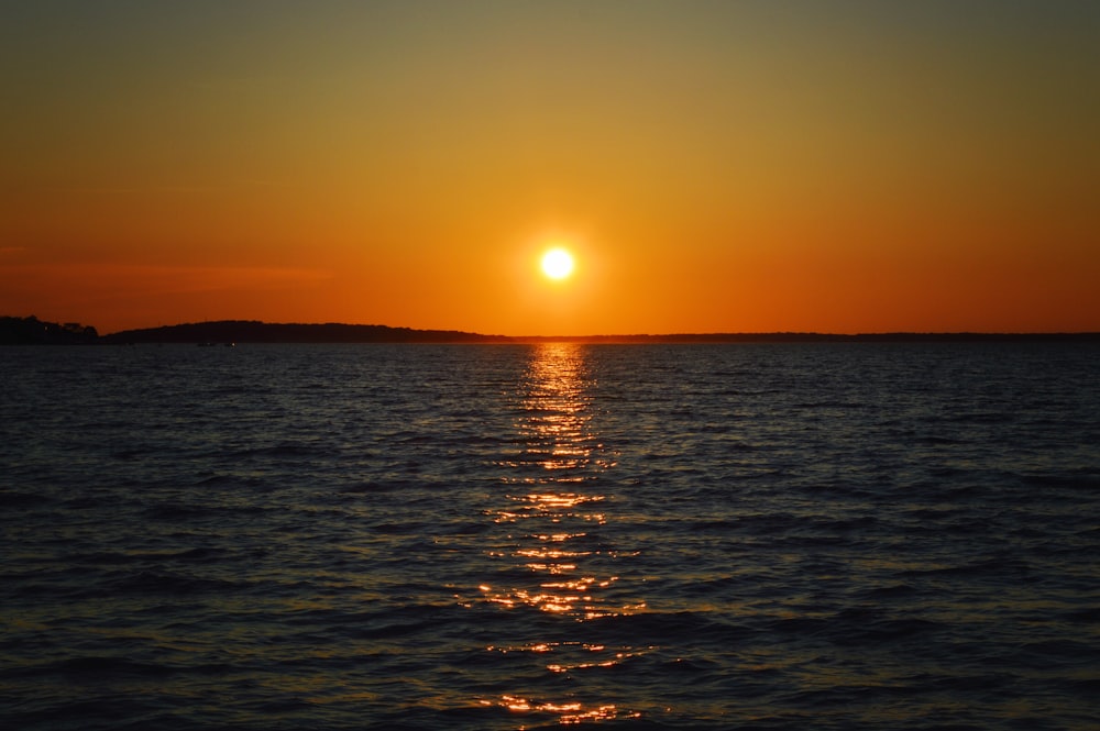 body of water during sunset