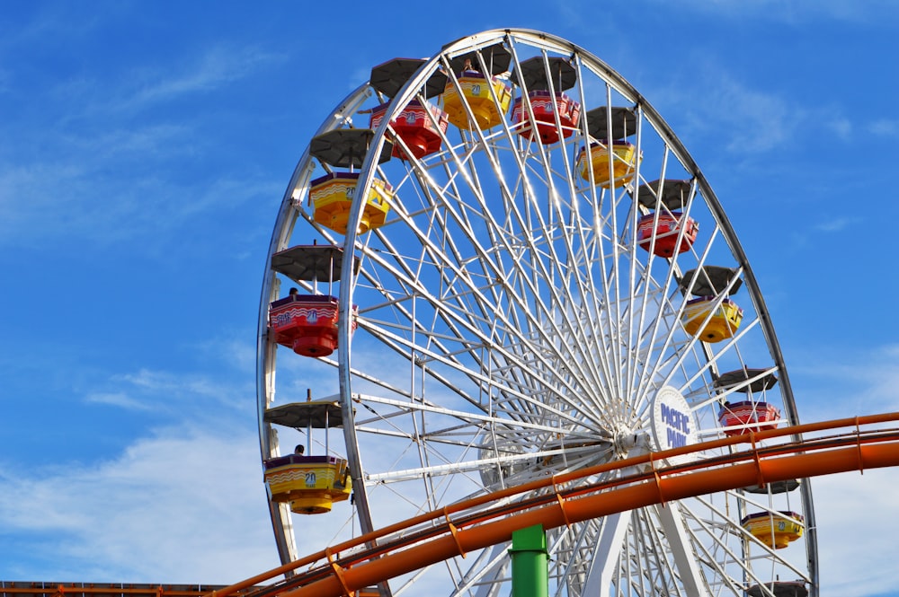 white and green ferris wheel under blue sky during daytime