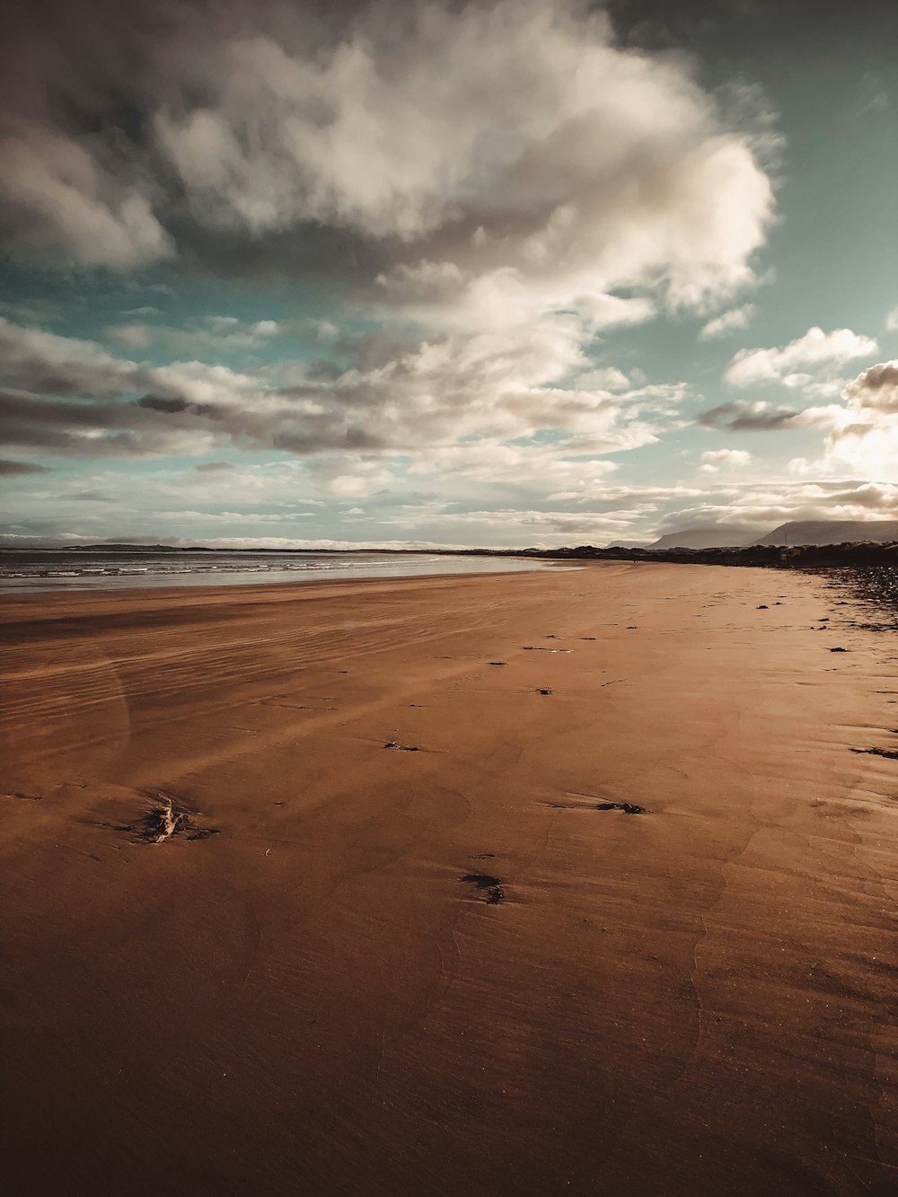 brown sand under cloudy sky during daytime