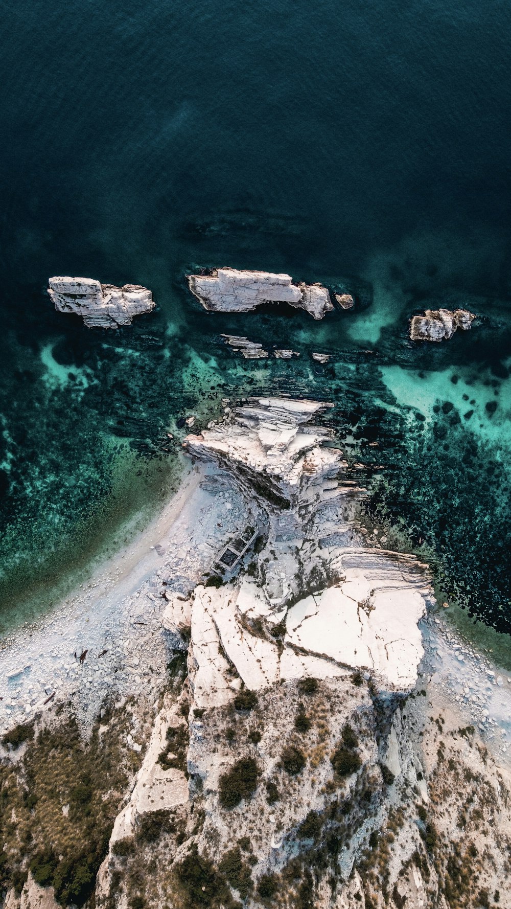 aerial view of white and gray rocky shore during daytime