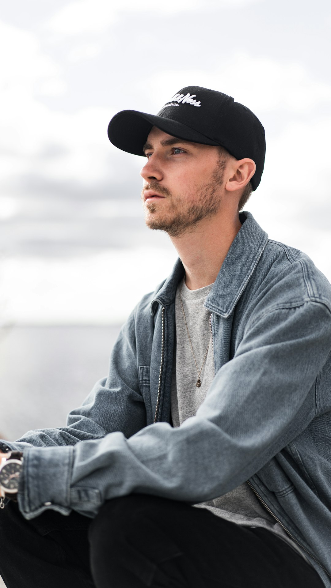 man in gray zip up jacket and black cap