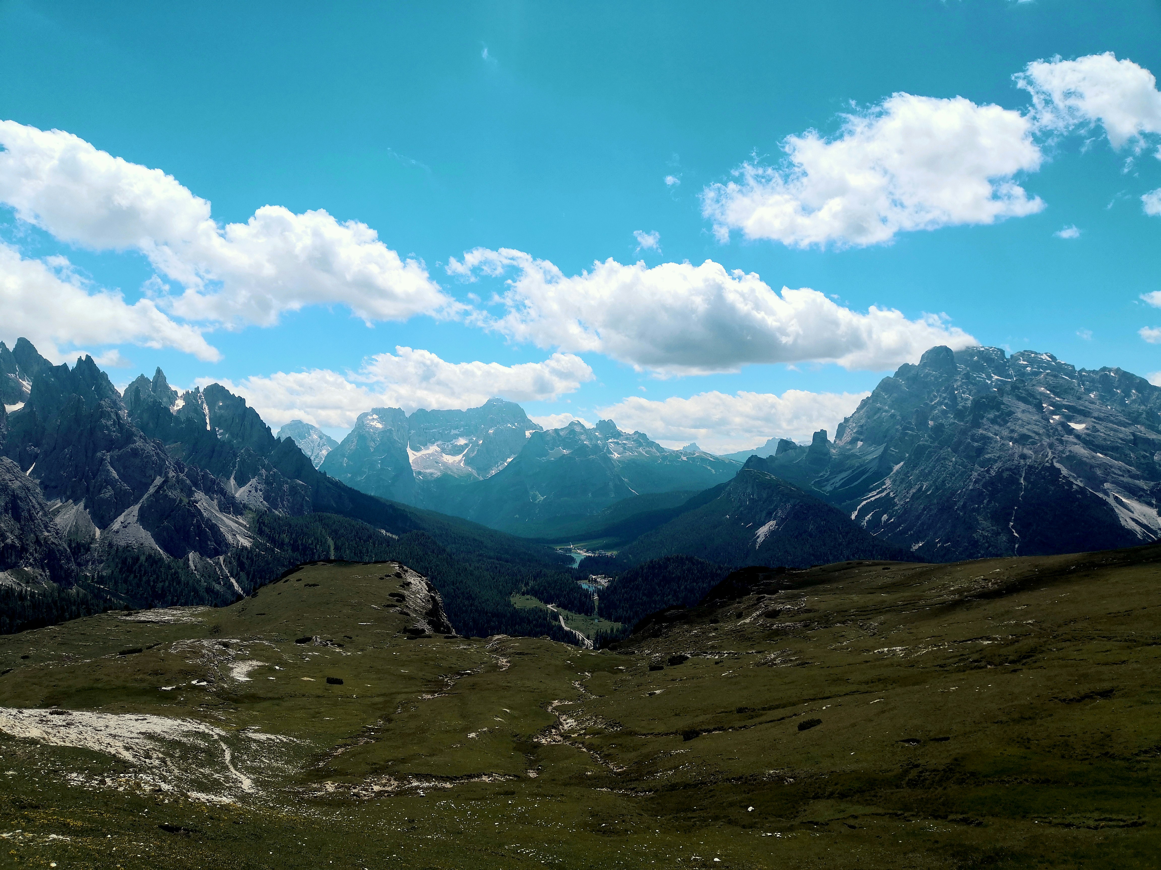 green grass field and mountains under blue sky during daytime, 