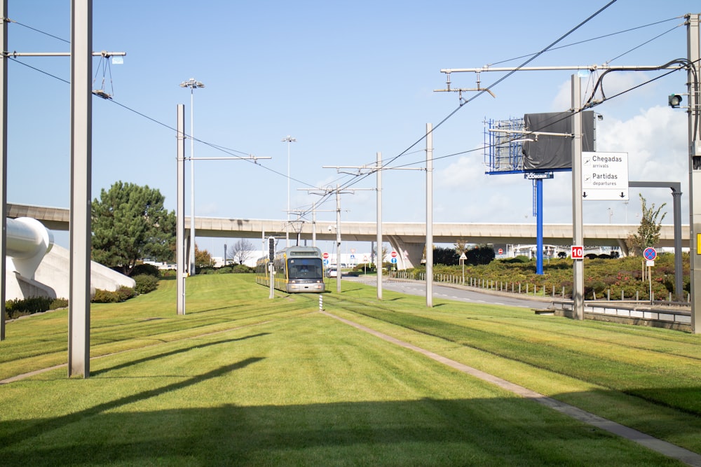 white and blue bus on green grass field during daytime