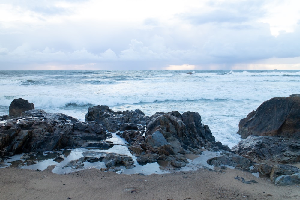 gray rock formation on seashore during daytime