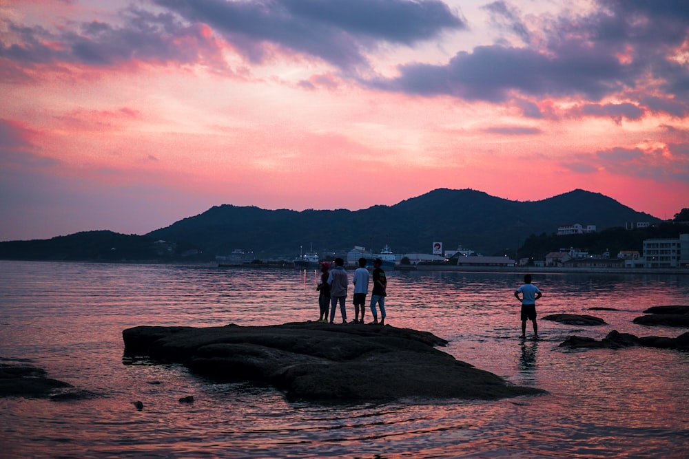 people on beach during sunset