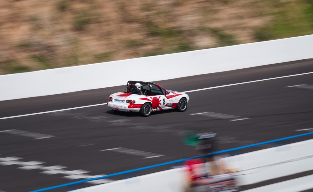 red and white racing car on track