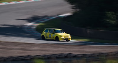 yellow and black car on road renault teams background