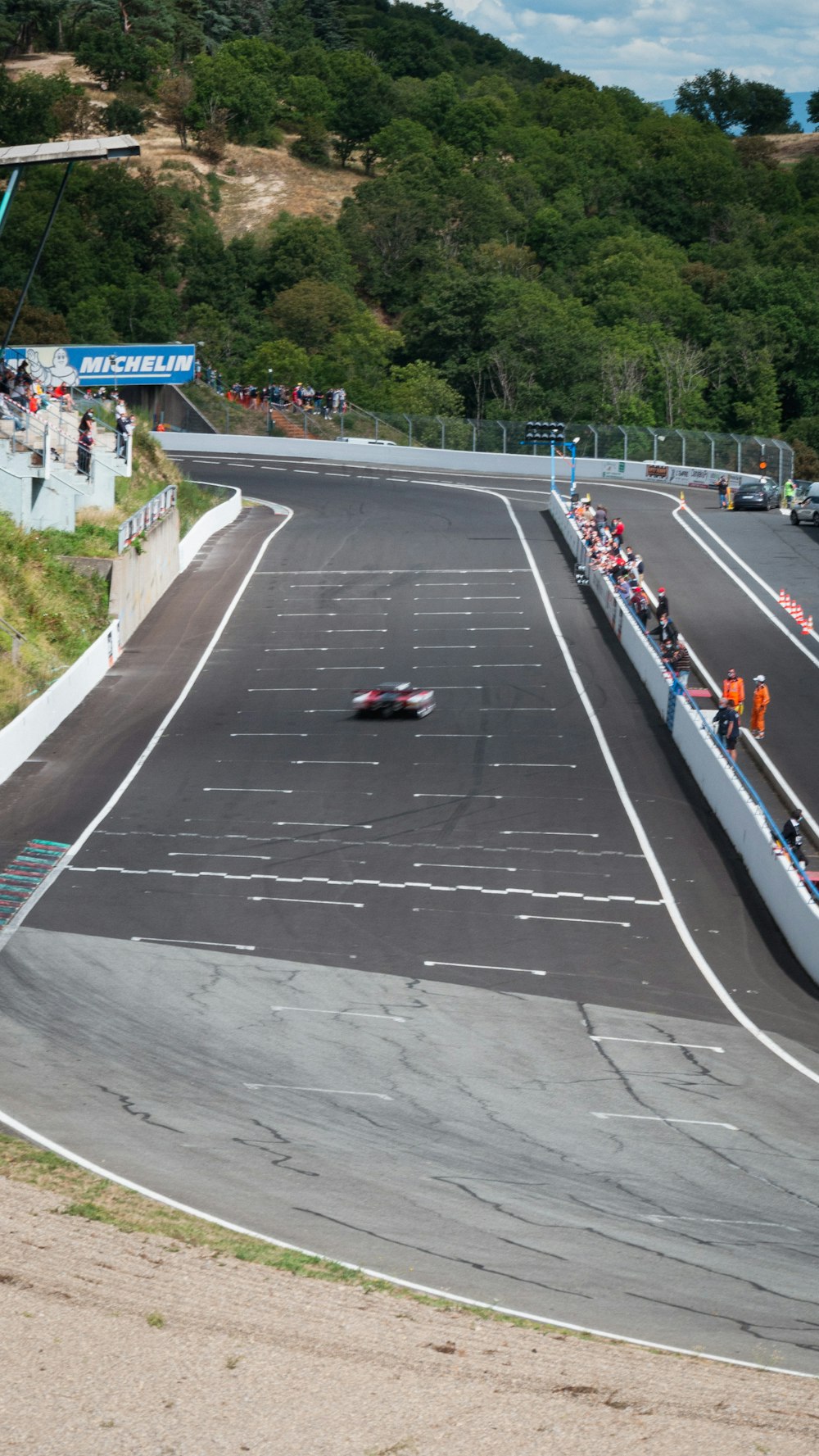 a group of people riding motorcycles on a race track