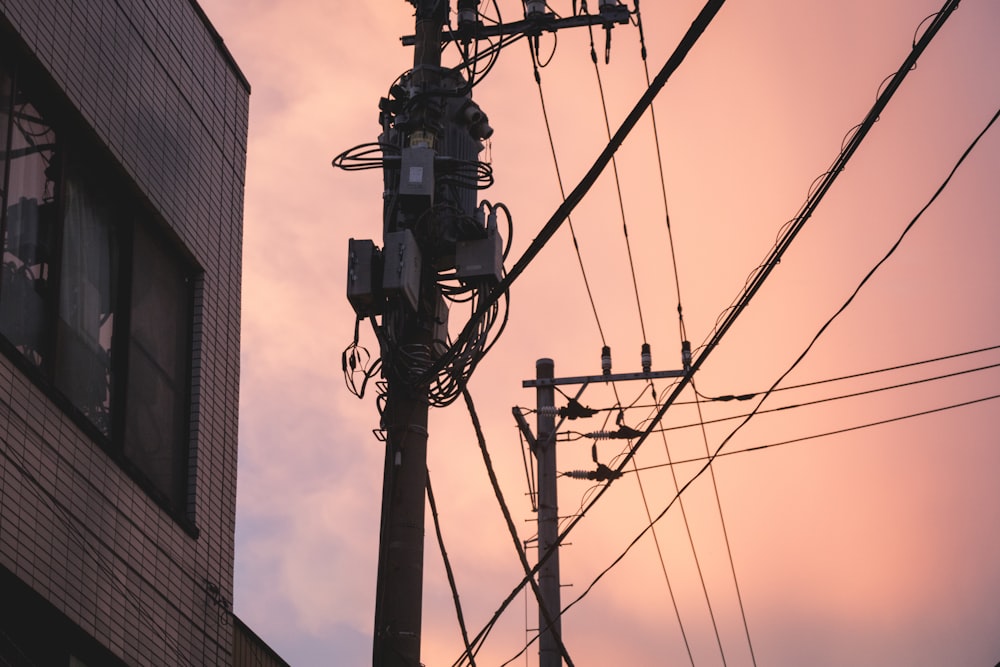 black electric post near brown concrete building during daytime