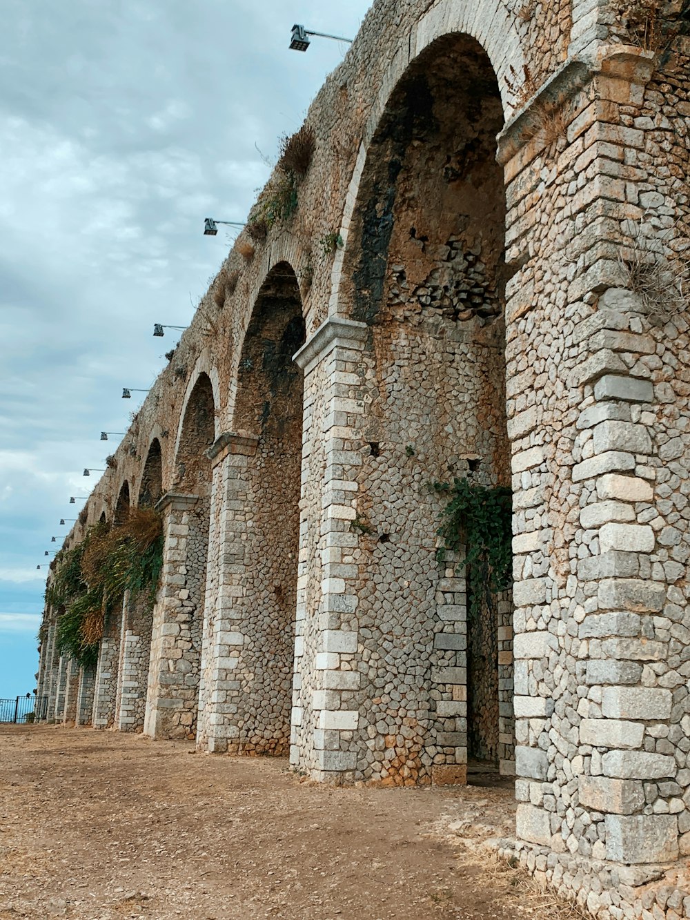 brown brick building under white clouds during daytime