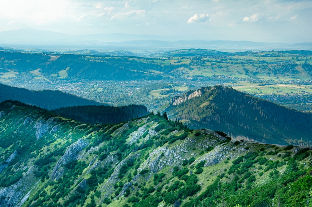 green and white mountains under white clouds during daytime