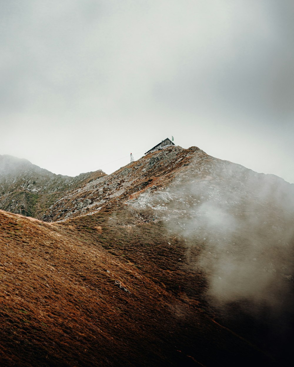 brown mountain under white clouds during daytime