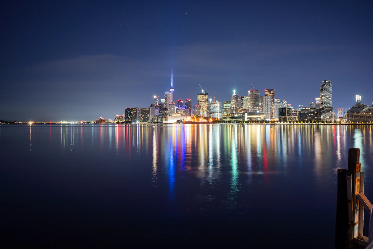 Toronto skyline and CN Tower reflected on Lake Ontario at night
