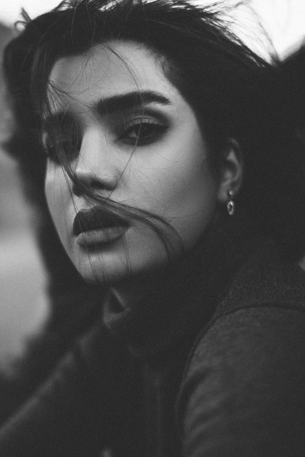 woman in black shirt with silver earrings