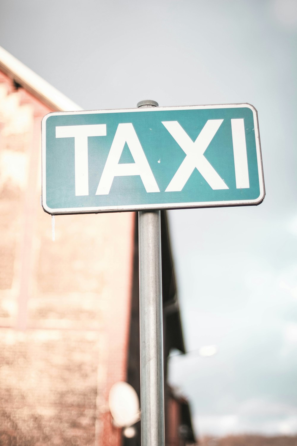 a close up of a street sign with a building in the background