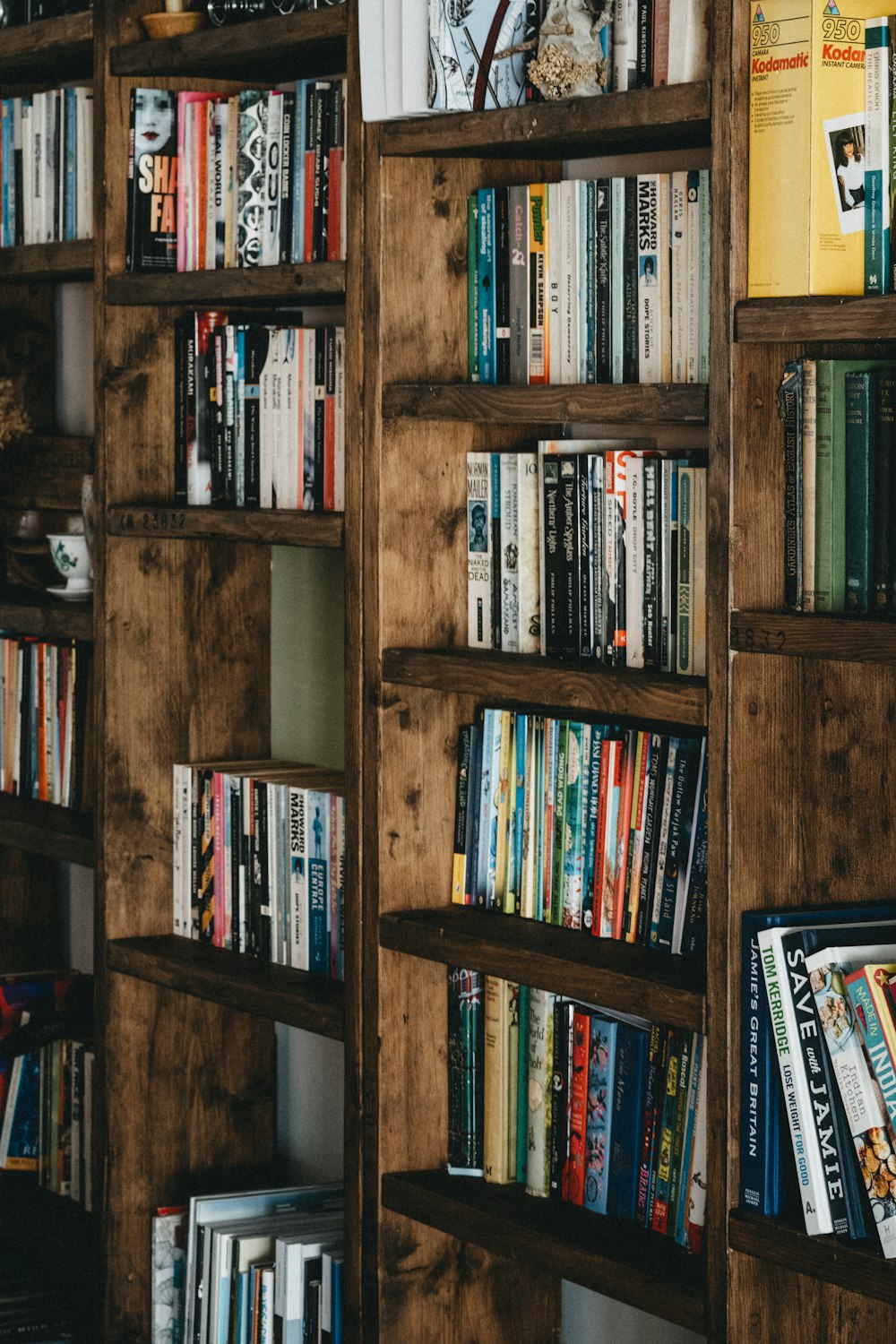 books on brown wooden shelf