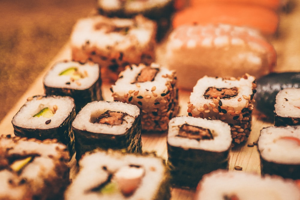sushi rolls on brown wooden table