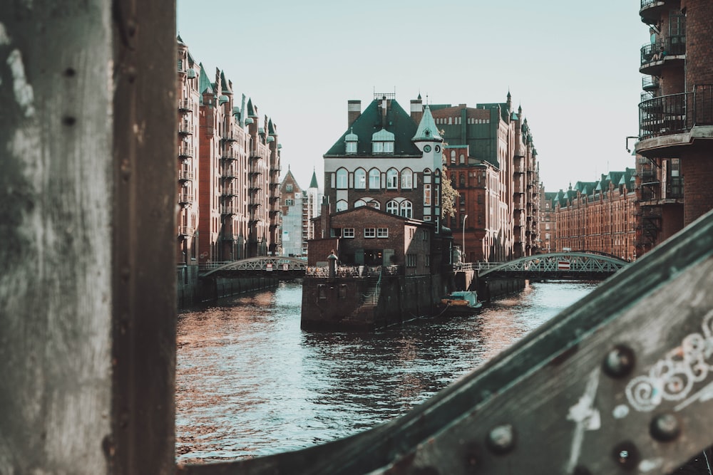 river between concrete buildings during daytime