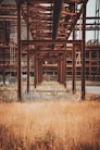 brown wooden building on brown grass field during daytime