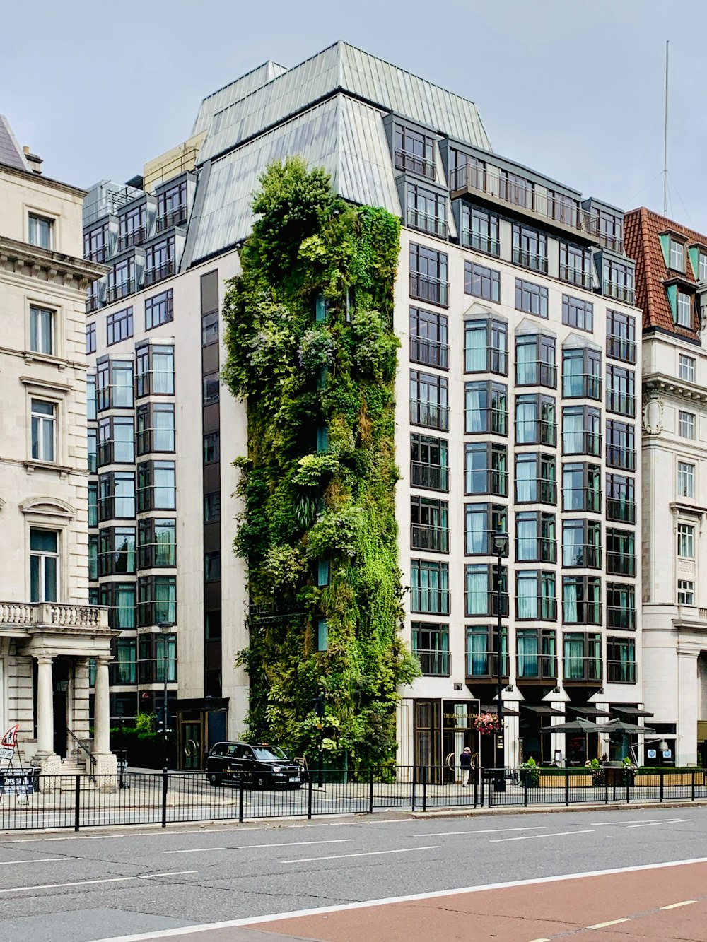 green trees in front of white concrete building during daytime