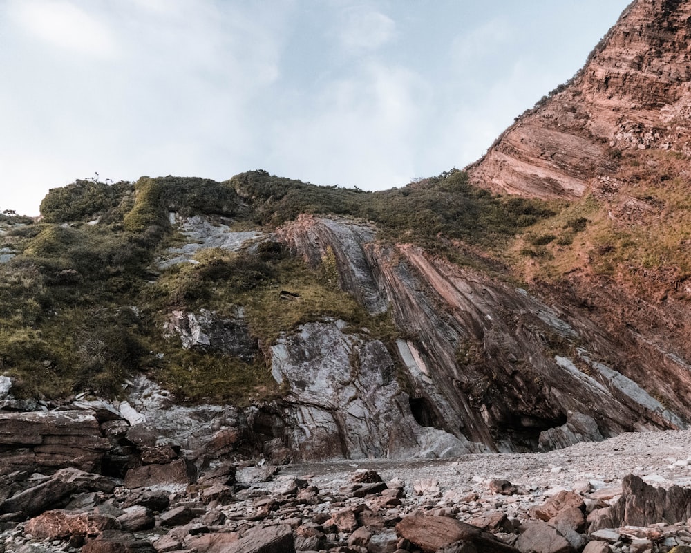 brown rocky mountain under white cloudy sky during daytime