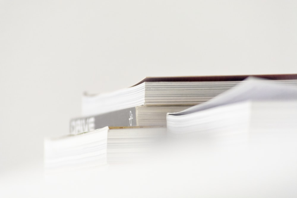 stack of books on white table