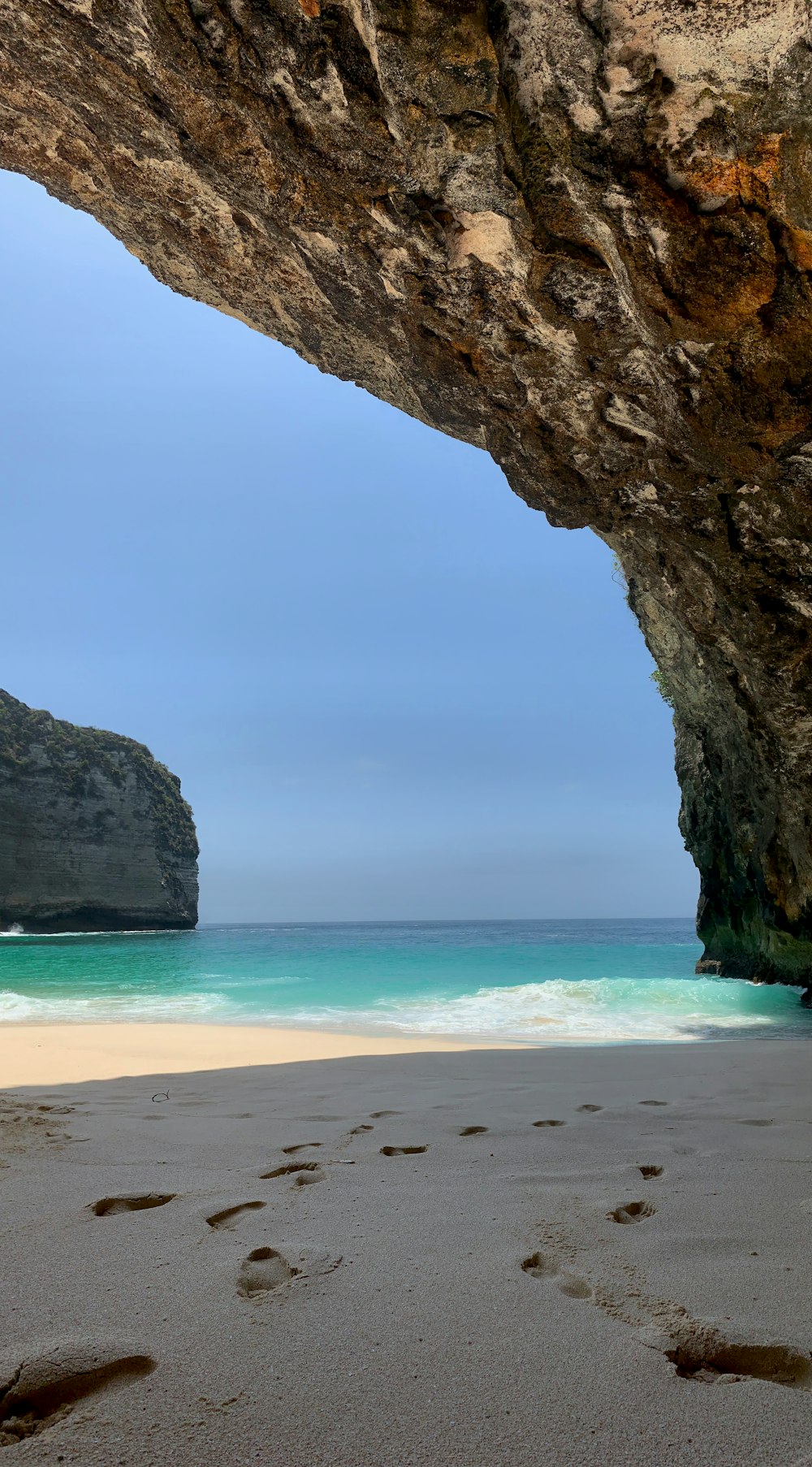 brown rock formation on beach during daytime