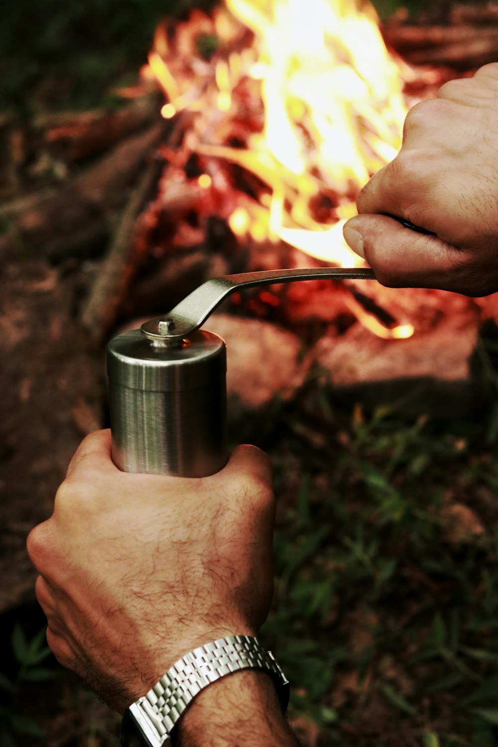 person holding stainless steel vacuum flask
