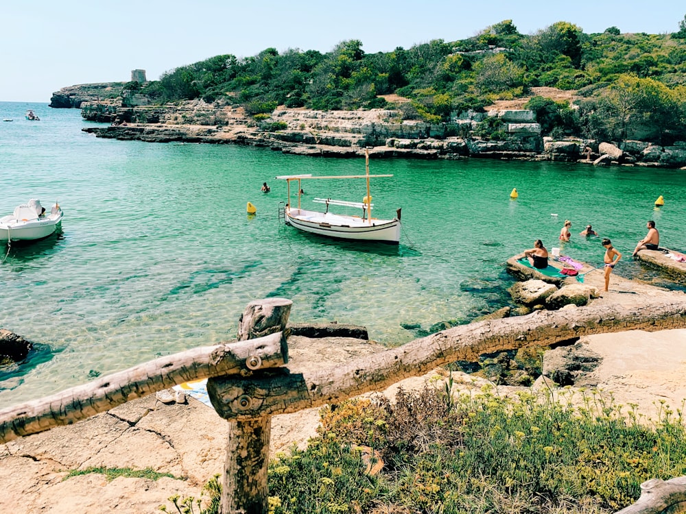 white and black boat on sea during daytime