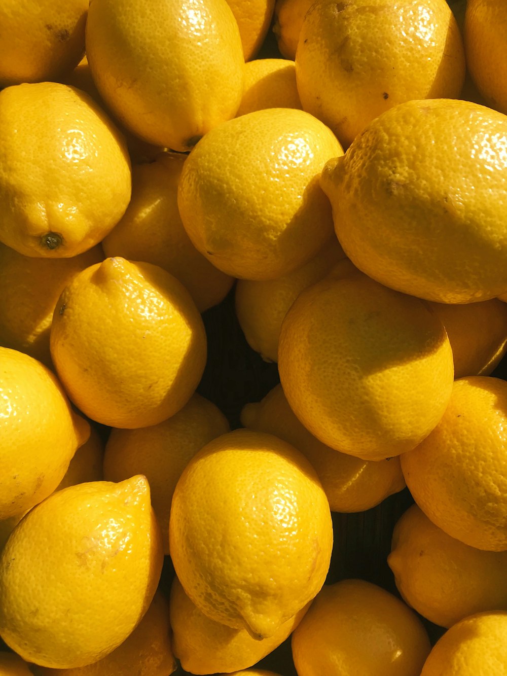 yellow lemon fruits on black surface