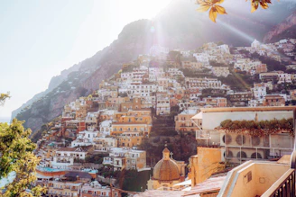 white and brown concrete buildings near mountain during daytime