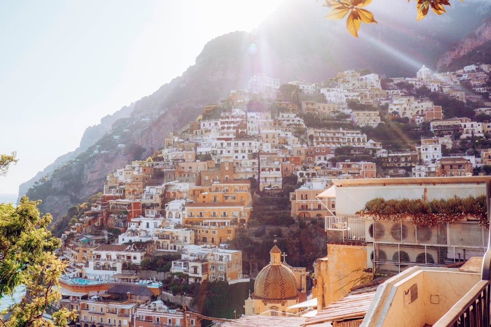 white and brown concrete buildings near mountain during daytime