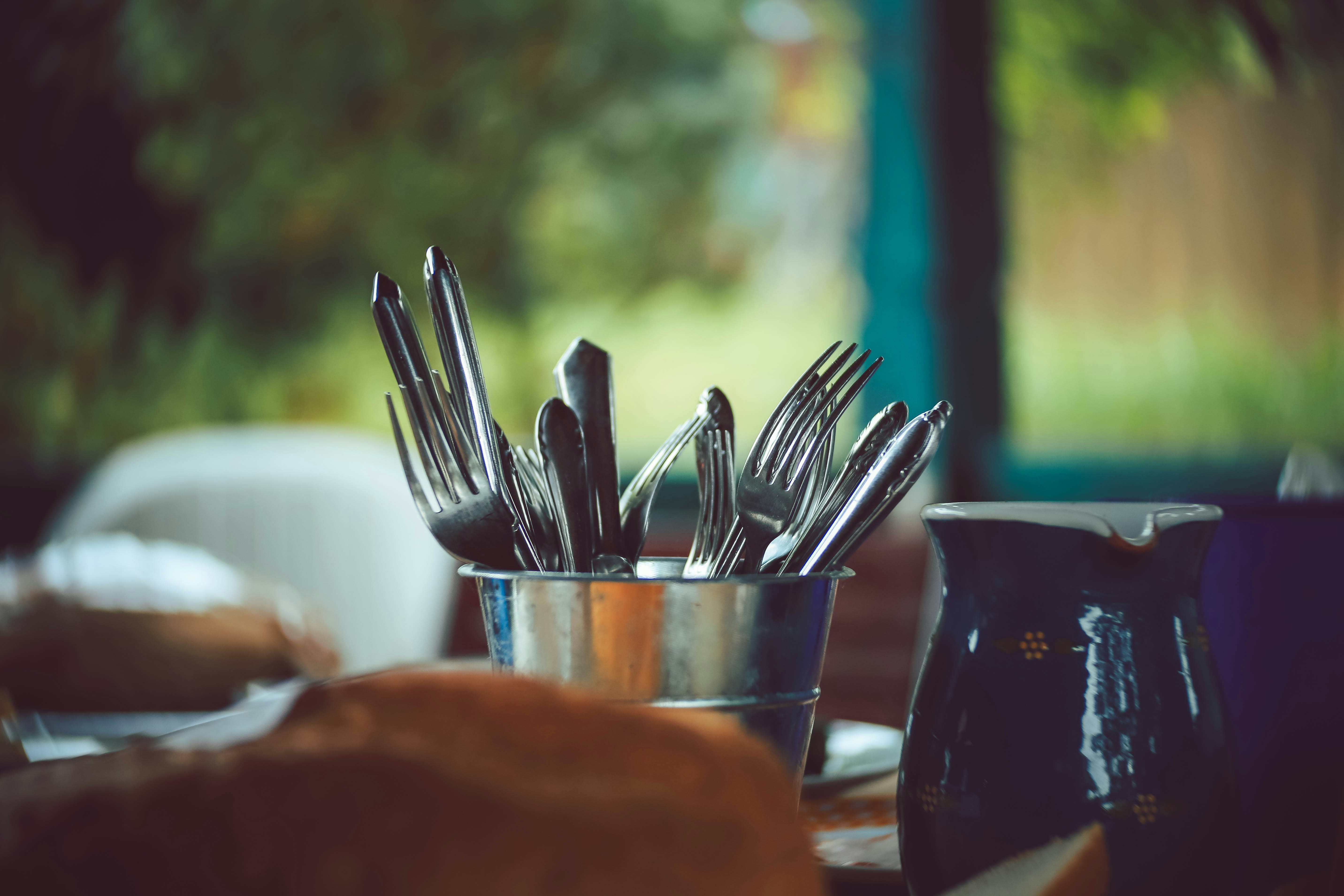 stainless steel spoons and forks on stainless steel round container