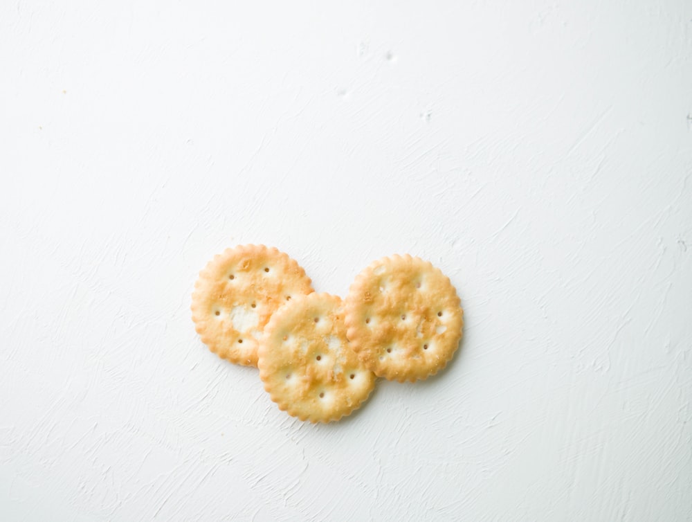 two brown cookies on white surface