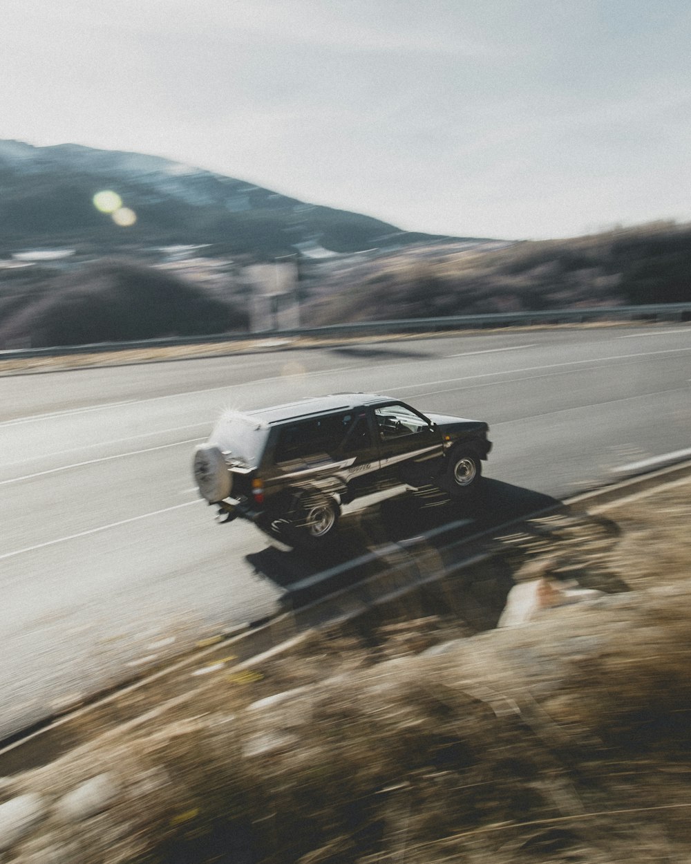 black suv on road during daytime