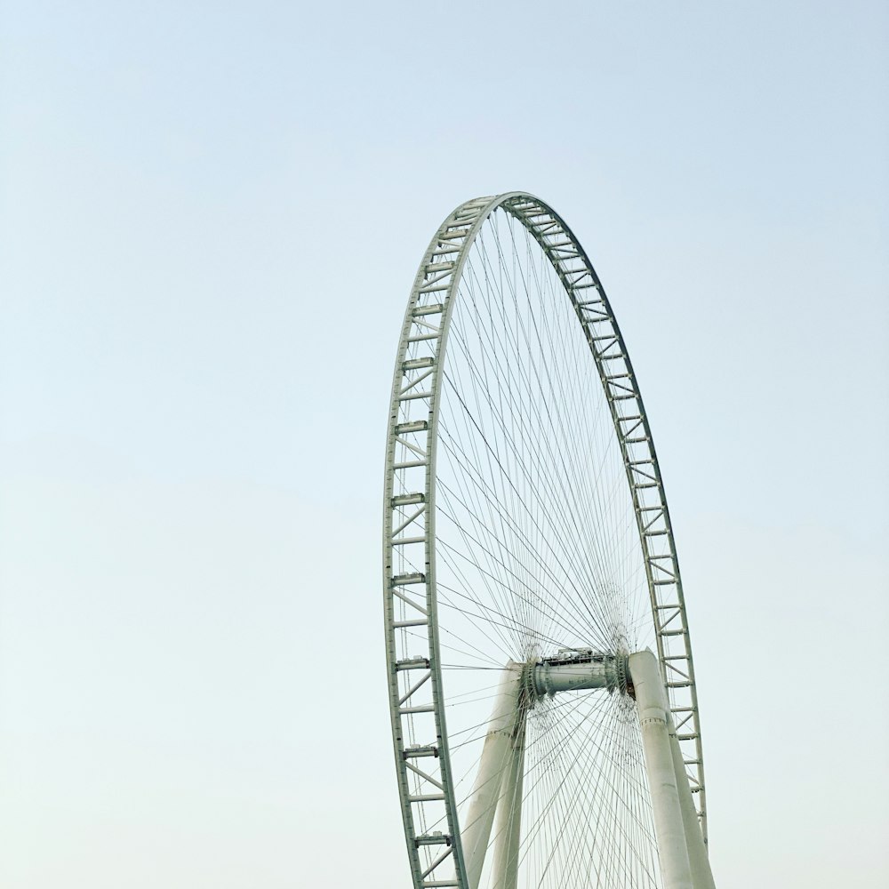 white ferris wheel under white sky