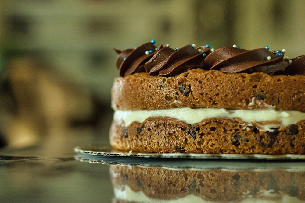 brown and white cake on clear glass plate